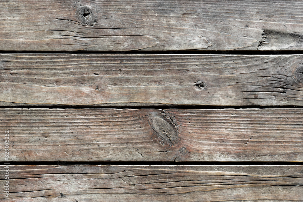 Texture of old weathered cracked wooden boards with knots and annual growth lines close up. Natural background for your design Texture of old weathered cracked wooden boards with knots and annual growth lines close up. Natural background for your design