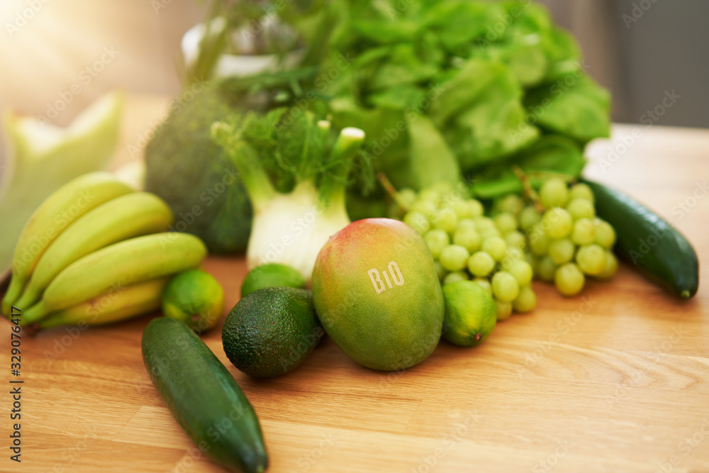Fresh green fruit and vegetables on wooden counter Fresh green fruit and vegetables on wooden counter