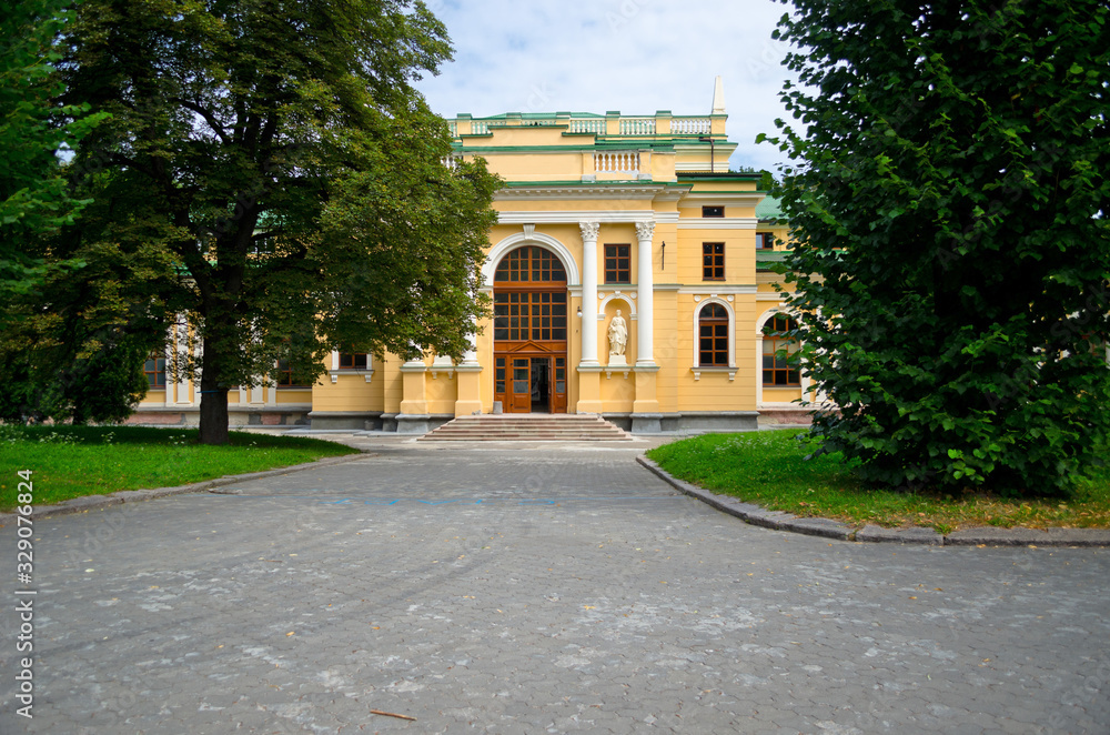 Obraz premium Green summer garden with lawn and trees. Park for hiking and country rest. A country house with its own garden courtyard. July 12, 2017, Lviv, Ukraine