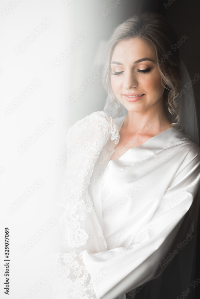 Luxury bride in white dress posing while preparing for the wedding ceremony Luxury bride in white dress posing while preparing for the wedding ceremony