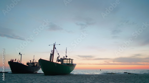 Scenic Seascape Video: Two Fishing Boats Morred to Shore Beach at Beautiful Vanilla Sunset over Sea in Summer
