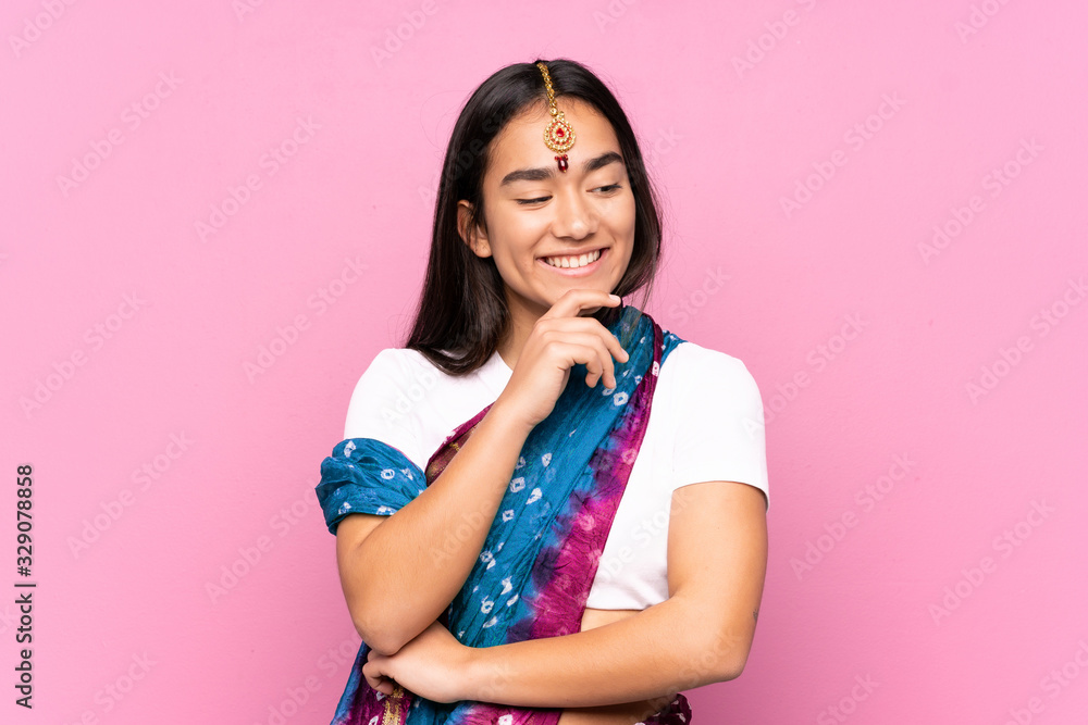 Young Indian woman with sari over isolated background looking to the side Young Indian woman with sari over isolated background looking to the side