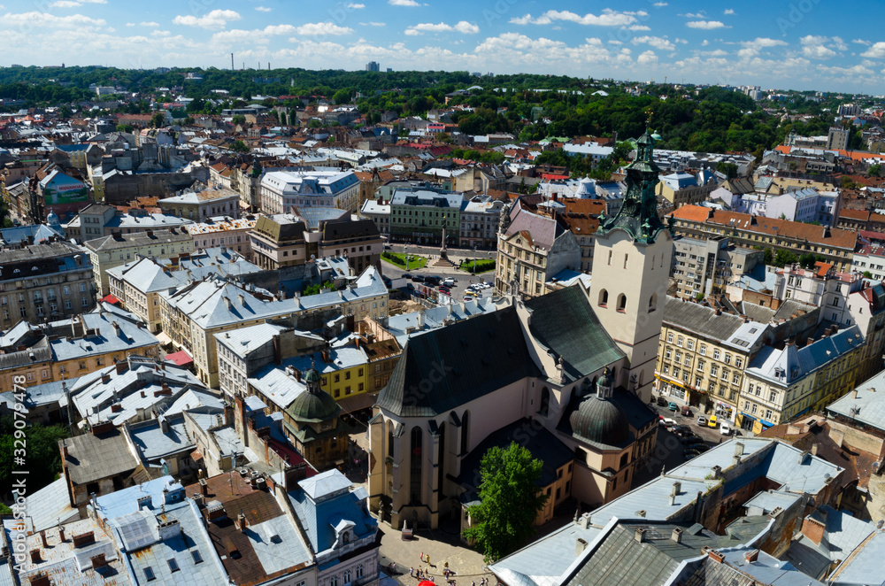 Obraz premium Panorama of the city of Lviv. Medieval city with red tiled roofs. A city for romantic people and lovers. Cozy Europe. Lviv, Western Ukraine, July 18, 2017