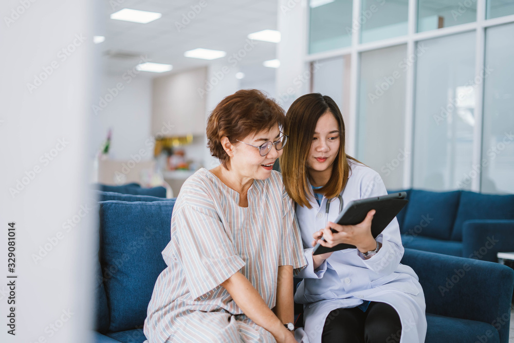 Young doctor consulting senior patient at health care clinic 