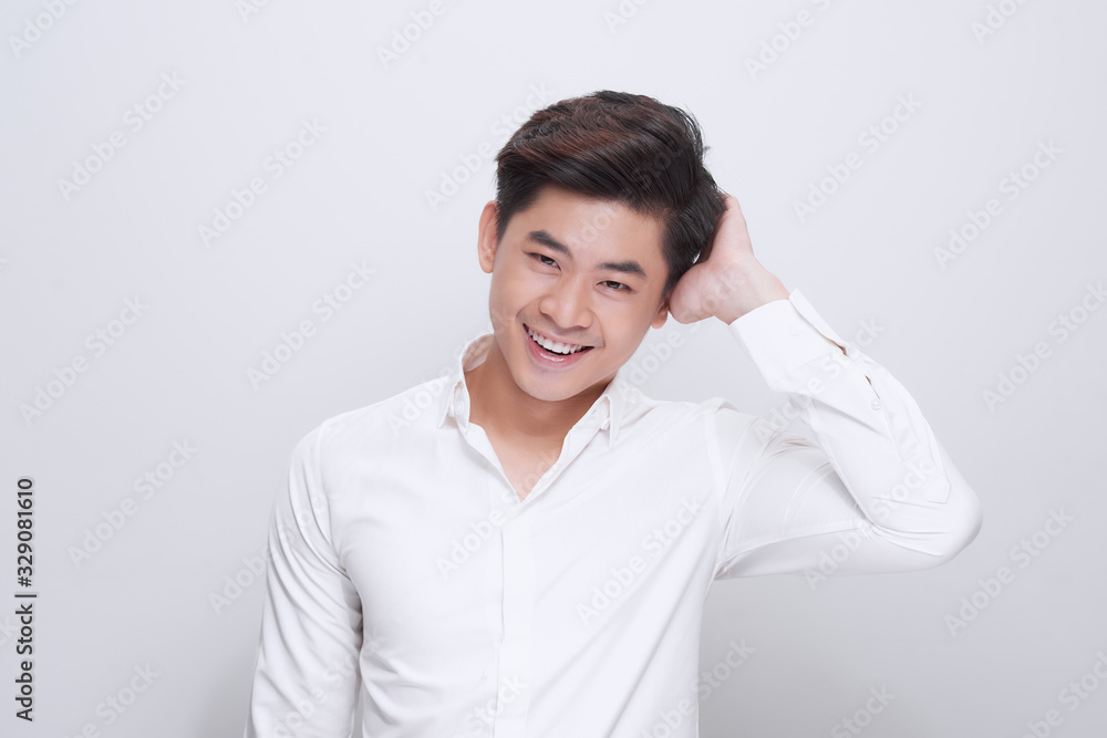 young handsome man laughing cheerfully and confidently with a casual, happy, friendly smile against white background young handsome man laughing cheerfully and confidently with a casual, happy, friendly smile against white background