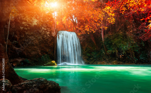 Beautiful waterfall with sunlight in autumn forest at Erawan National Park, Thailand, Nature landscape , Beautiful steam green forest nature