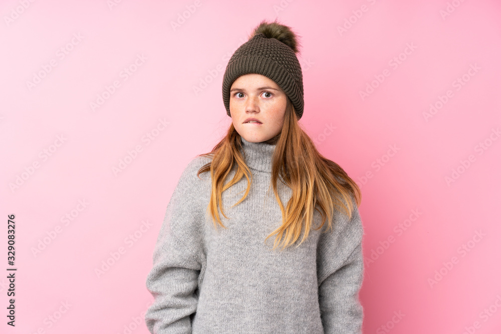 Ukrainian teenager girl with winter hat over isolated pink background having doubts and with confuse face expression Ukrainian teenager girl with winter hat over isolated pink background having doubts and with confuse face expression