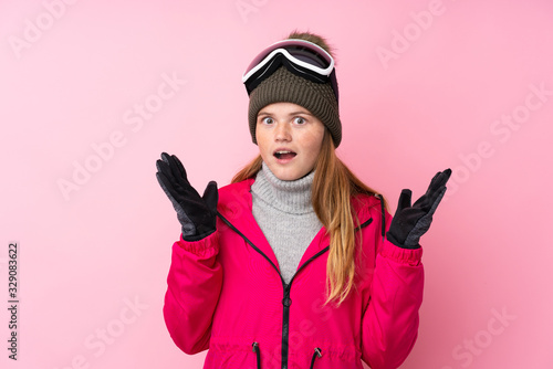Ukrainian teenager skier girl with snowboarding glasses over isolated pink background with surprise facial expression