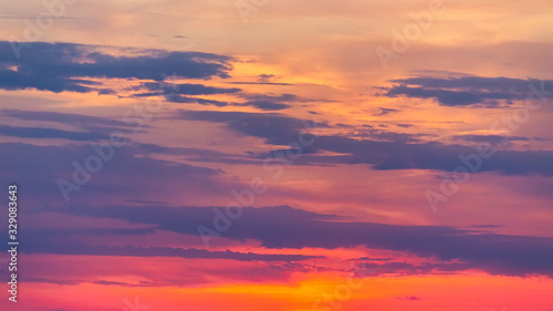 Background created from sky at sunset covered with red clouds.