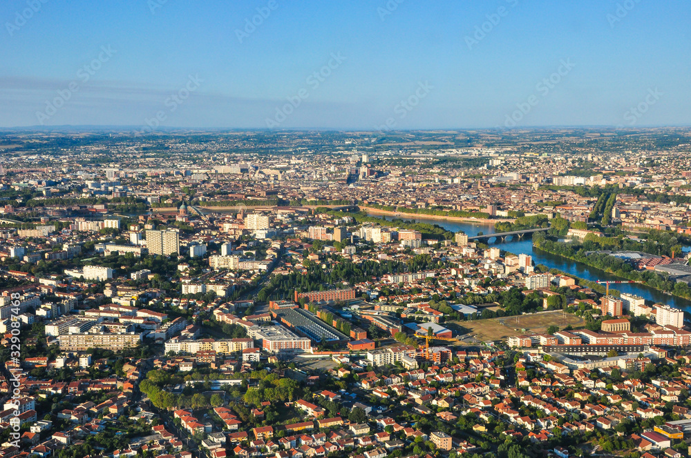 Aerial shot from a plane of the city of Toulouse with Pont Neuf and Saint-Pierre  on a nice late afternoon light 