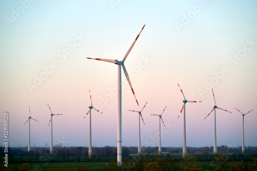 Cuadro en lienzo Wind turbines on countryside wind park at sunset