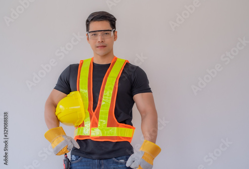 The foreman stands with a yellow safety helmet and wears gloves on a white background.