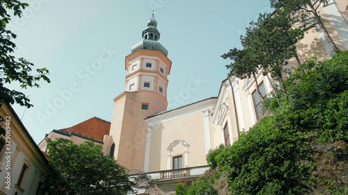 Mikulov Castle Tower with Dome from Green Courtyard with Trees on Rock on Sunny Summer Day, Czech Republic, Europe.