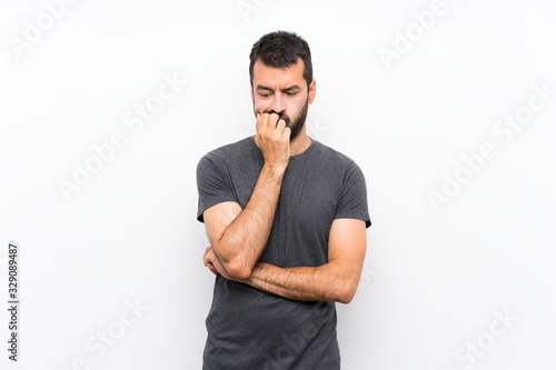Young handsome man over isolated white background having doubts