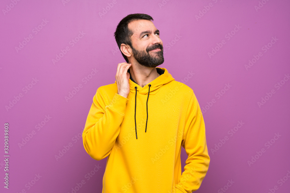 Handsome man with yellow sweatshirt thinking an idea Handsome man with yellow sweatshirt thinking an idea