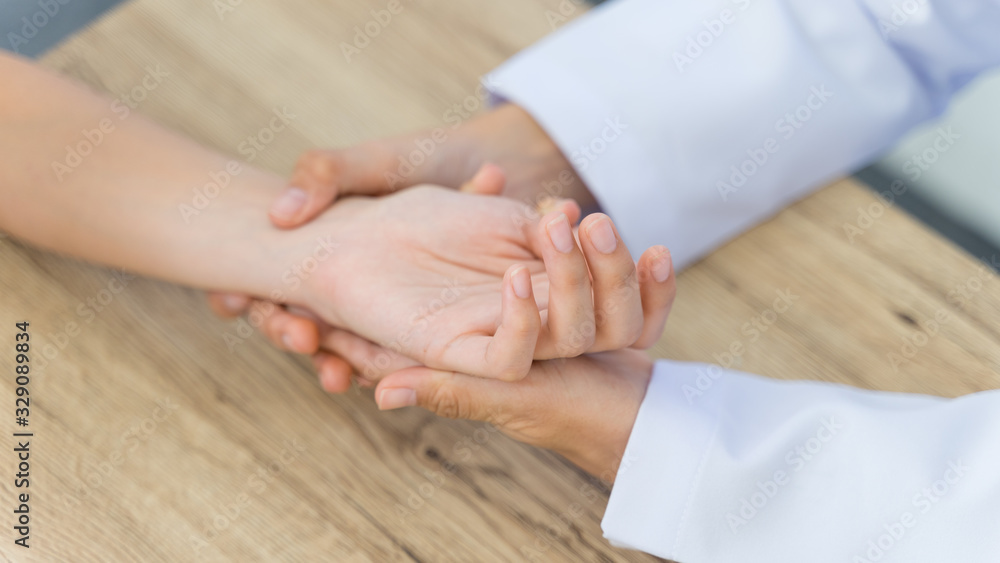 Close up of a doctor holding the patient hands doing basic medical examination and diagnostic. Close up of a doctor holding the patient hands doing basic medical examination and diagnostic.