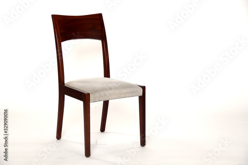 Wooden chair with cushion shot against white background
