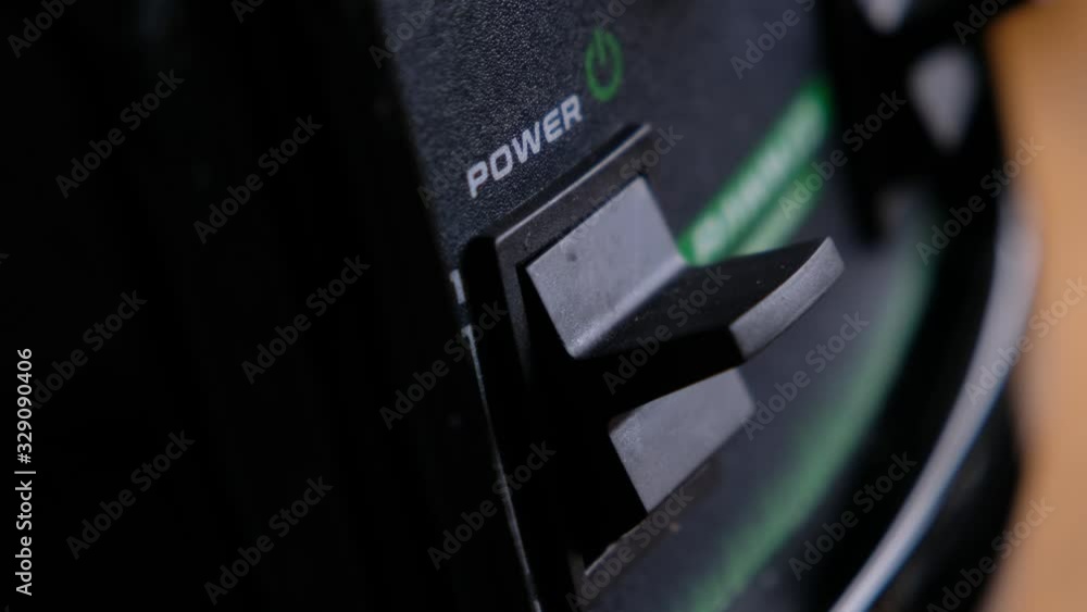 Somebody turn switch on the power button on an electrical device