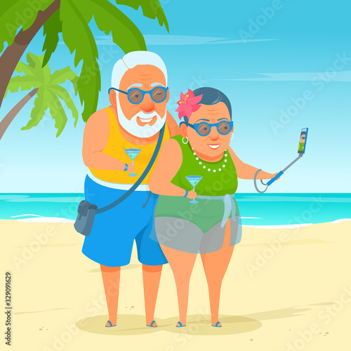 An active happy elderly tourist couple standing on the sea beach, taking a selfie shot. Summer sunny day at the resort. Cute funny grandma and grandpa. A cartoon senior adult in swimwear.