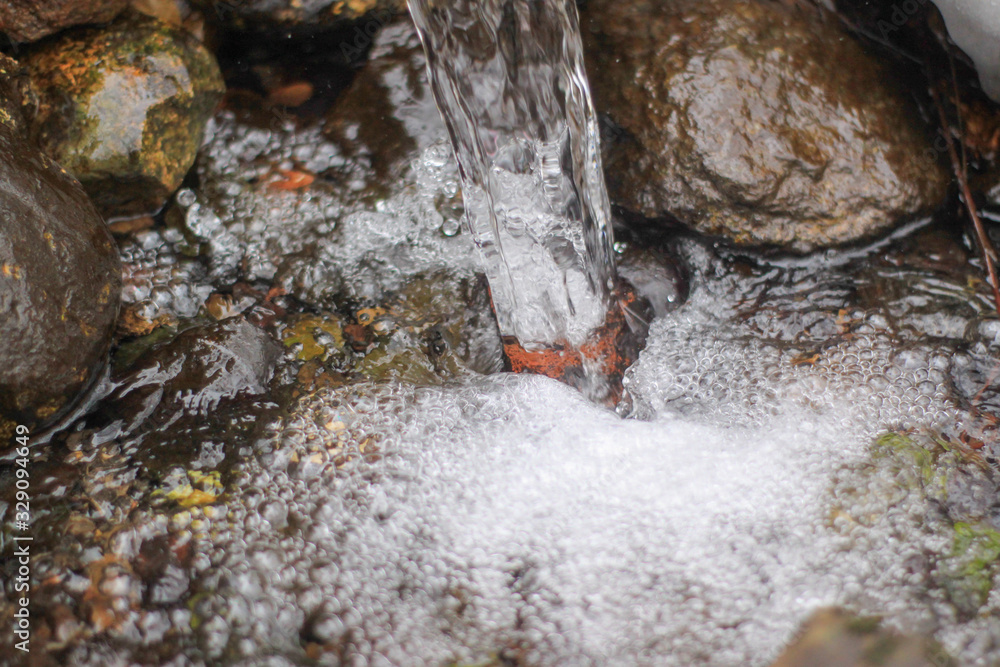fast stream in the Park. open water, rocks and foam.