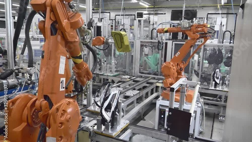 Production / Glueing of Headlamps on Automated Industrial Robotic Arm, Robotic Center, Robotic Glueing Headlamps / Headlights / Front Light to Cars, Robotic Glass Loading in Automotive Factory