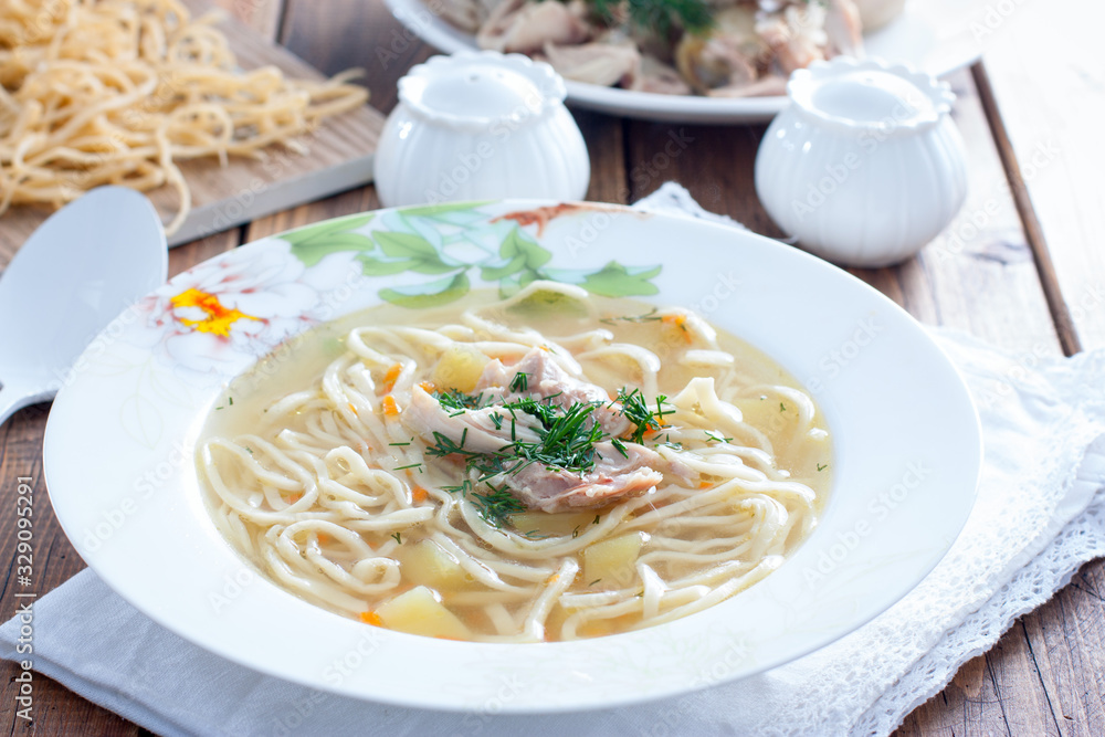 Homemade chicken soup with homemade egg noodles, horizontal Homemade chicken soup with homemade egg noodles, horizontal