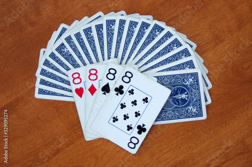 blue playing cards in fan with four eights showing