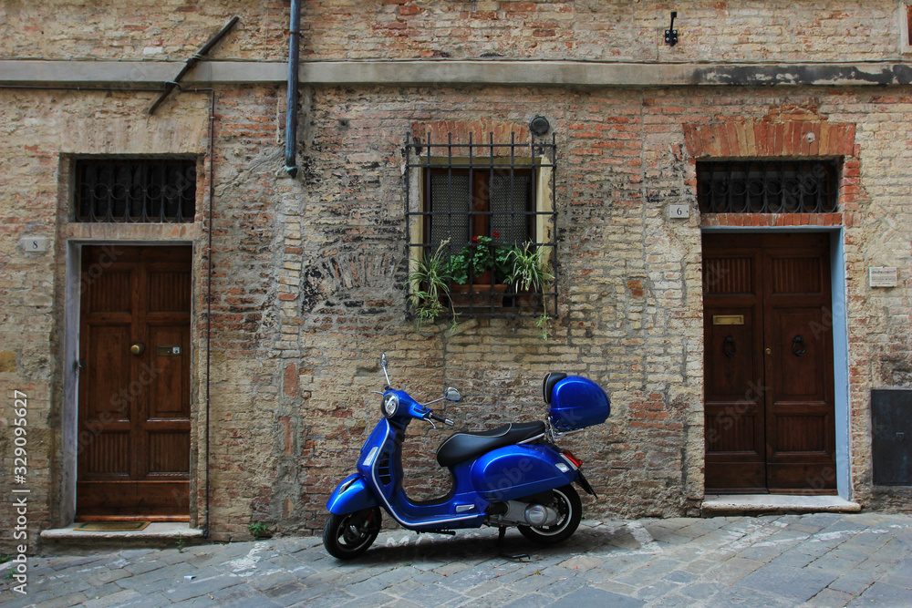 Scooter in Italian street in front of old house