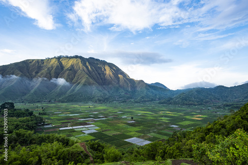 Stunning aerial view of some agricultural fields in Sembalun. Sembalun is situated on the slope of mount Rinjani and is surrounded by beautiful green mountains. Sembalun, Lombok, Indonesia