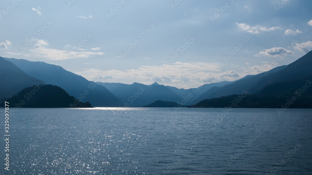 panoramic view of Lake Como, mountains and blue sky from tower of Castello di Vezio, Varenna, Como lake, Lombardy, Italy