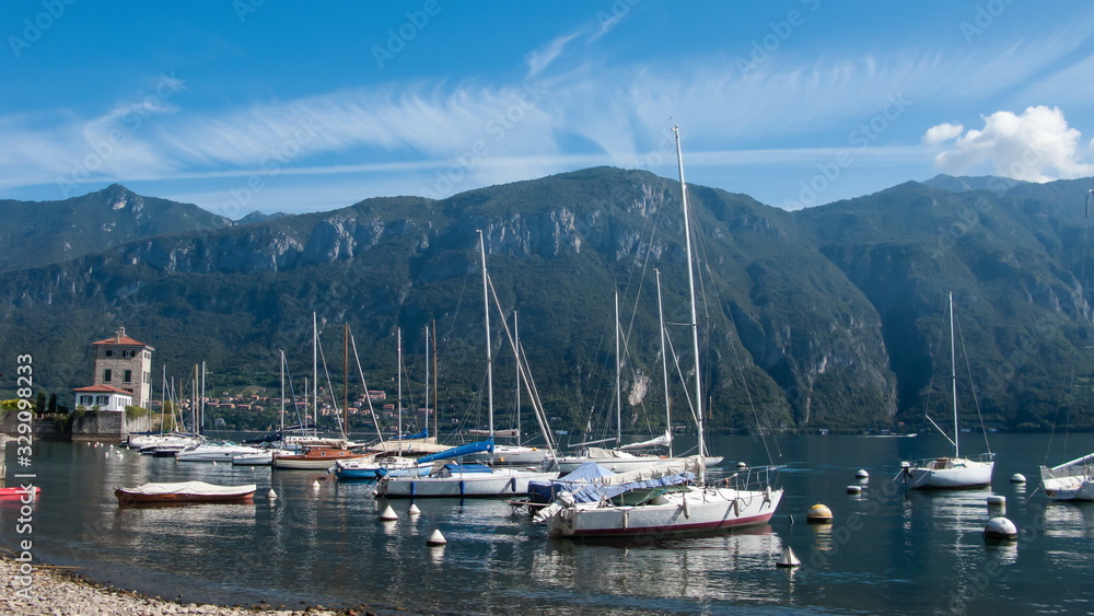 blue sky, white clouds, mountains, yachts, lake Сomo, Bellagio, Italy