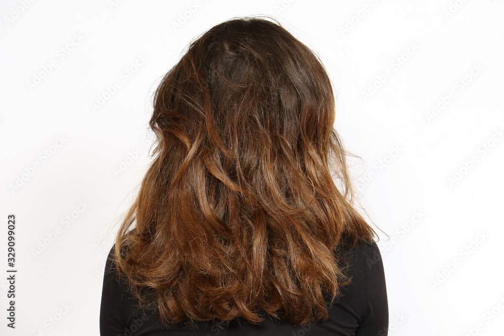 Naklejka premium Rear view of natural wavy long hair. Hair care concept on white background with copy space