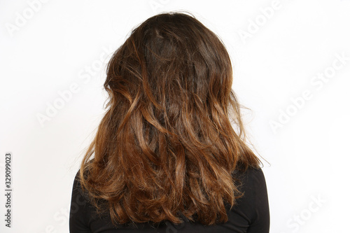 Rear view of natural wavy long hair. Hair care concept on white background with copy space