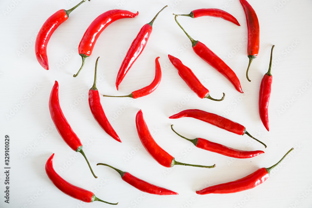 Red chili peppers on a white background. Healthy food. Fresh vegetables. Flat lay, top view, overhead. Cinco de mayo attribute Red chili peppers on a white background. Healthy food. Fresh vegetables. Flat lay, top view, overhead. Cinco de mayo attribute