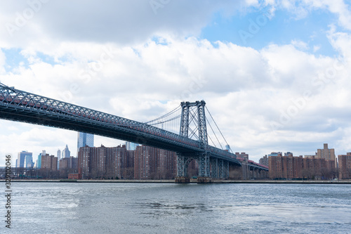 The Williamsburg Bridge over the East River with a view of the Lower East Side of New York City