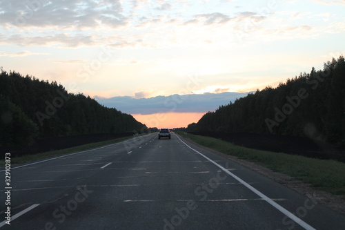 car rides on an empty highway in the evening