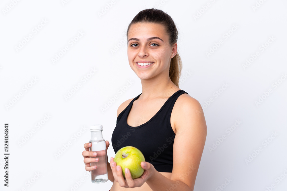 Teenager girl with an apple and a bottle of water over isolated background Teenager girl with an apple and a bottle of water over isolated background