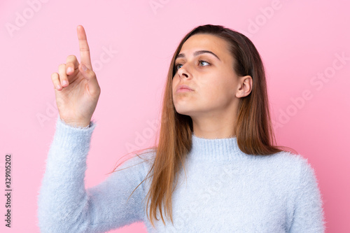 Wallpaper Mural Teenager girl with blue sweater over isolated pink background touching on transparent screen Torontodigital.ca