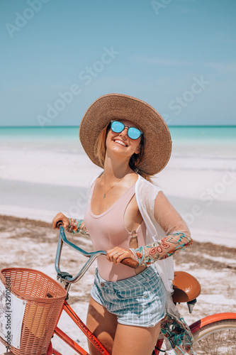 Wallpaper Mural Young woman riding a bike in Holbox, Mexico during her holidays Torontodigital.ca