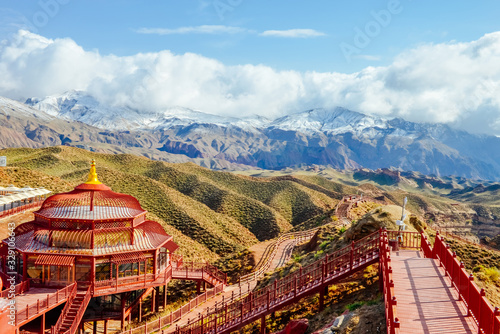 Ethnic house on mountain top at Pingshan Lake Valley photo