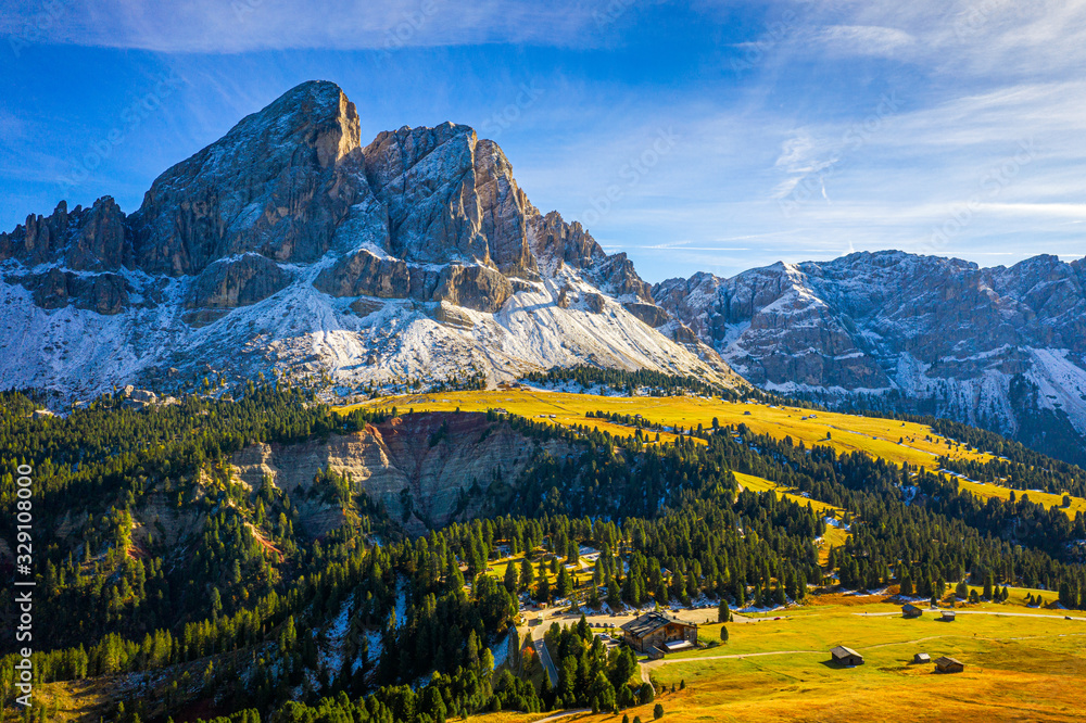 Stunning view of Peitlerkofel mountain from Passo delle Erbe in Dolomites, Italy. View of Sass de Putia (Peitlerkofel) at Passo delle Erbe, with wooden farm houses, Dolomites, South Tyrol, Italy.