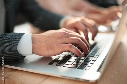close up. businessman typing on laptop keyboard. photo