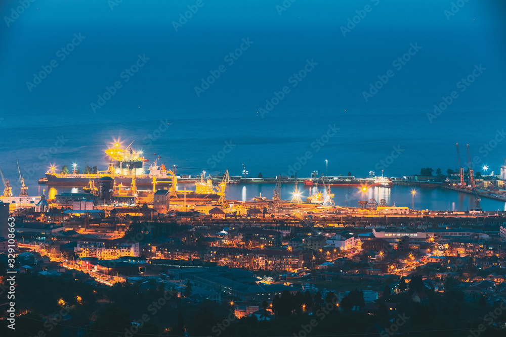 Batumi, Adjara, Georgia. Aerial View Of Urban Cityscape And Port At Evening Or Night. Industrial Zone.