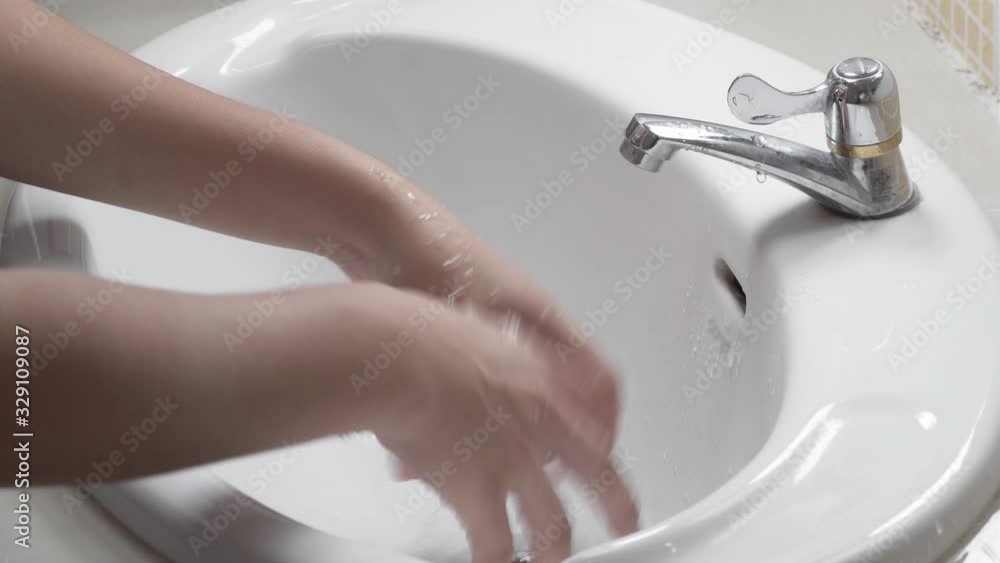 Close up of female lathering hands with soap before washing Close up of female lathering hands with soap before washing