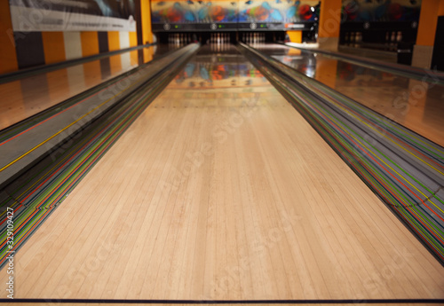 Empty wooden alley lane in modern bowling club