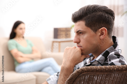 Unhappy man after quarrel with his girlfriend indoors. Relationship problems