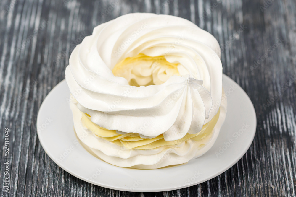 Meringue with lemon cream on a white napkin Meringue with lemon cream on a white napkin