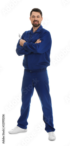 Full length portrait of professional auto mechanic with wrench on white background