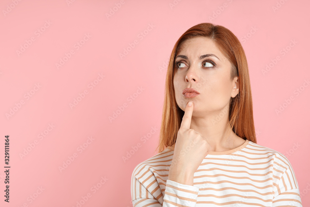 Pensive woman on pink background, space for text. Thinking about answer to question Pensive woman on pink background, space for text. Thinking about answer to question