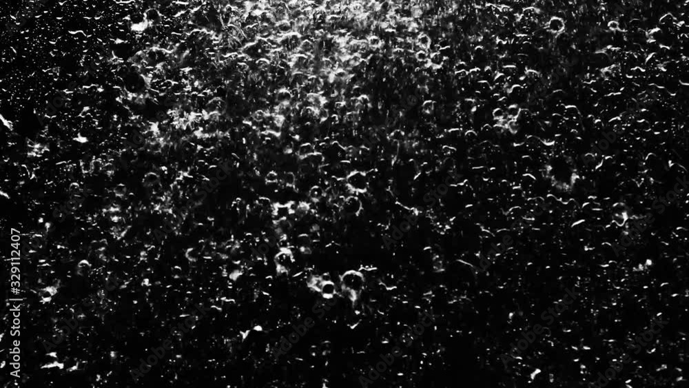 Droplets of rain falling on the surface on an isolated background Droplets of rain falling on the surface on an isolated background
